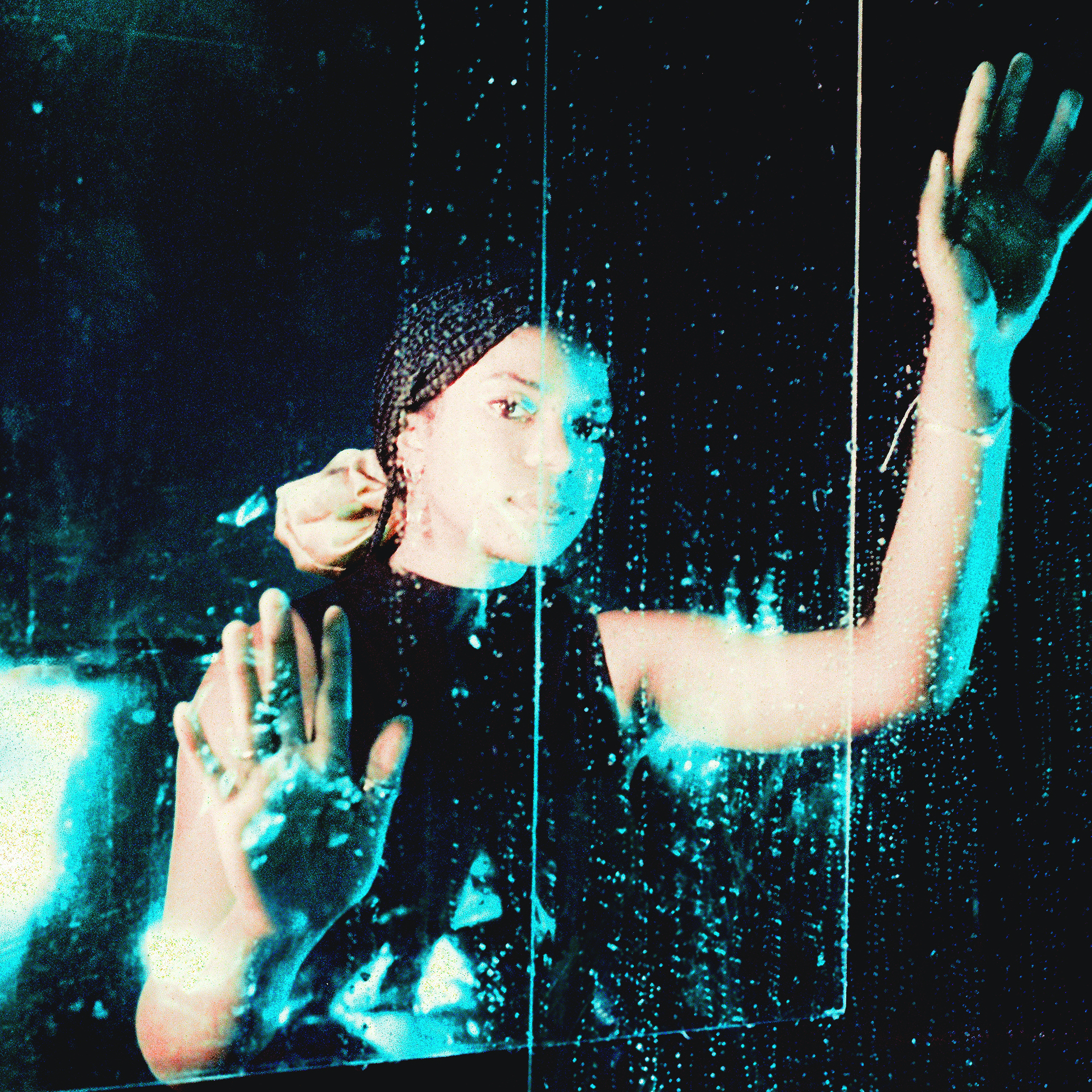 cover art for plastic/bending - an image of Dani on film behind glass